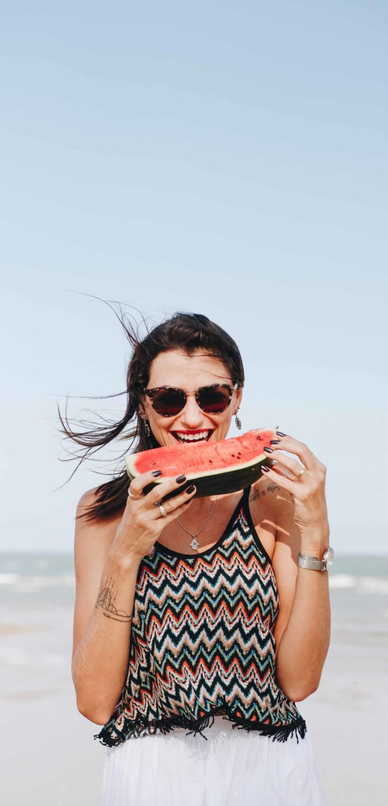 woman-eating-watermelon-at-the-beach-R2E5TKF-scaled-1.jpg